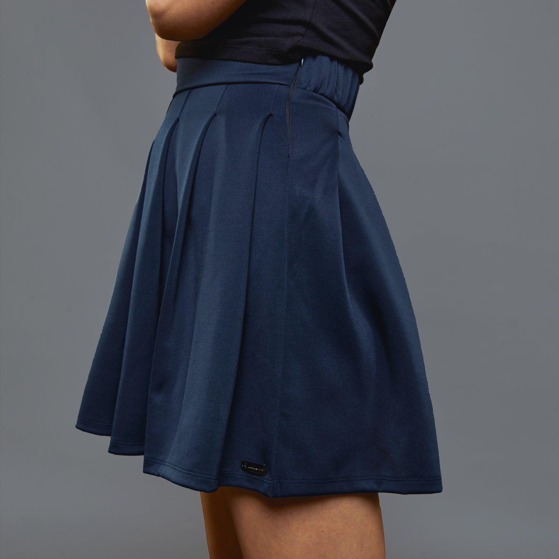 a person in a blue shirt and a black skirt 